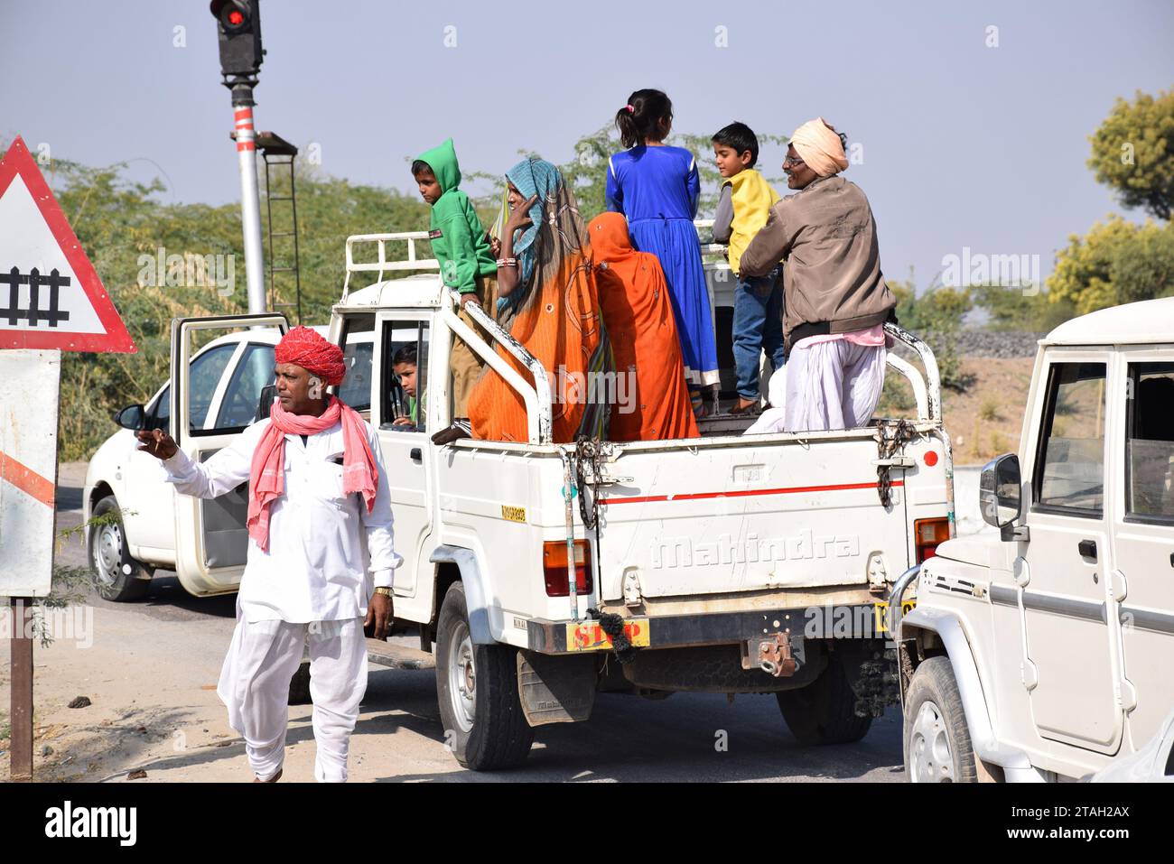 Indische Leute warten auf einem LKW auf die Bahnüberfahrt auf der Straße nach Jodhpur, Rajasthan - Indien Stockfoto