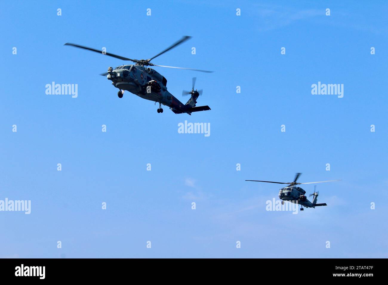 Zwei MH-60R Sea Hawk Helikopter, die an den „Sumpffüchsen“ der Helicopter Maritime Strike Squadron (HSM) 74 befestigt sind, nehmen an einer Zeremonie des Kommandowechsels an Bord des Flugzeugträgers USS Dwight D. Eisenhower (CVN 69) im Golf von Oman am 17. November 2023 Teil. Als Teil der Dwight D. Eisenhower Carrier Strike Group (IKECSG), HSM 74 im US 5th Fleet Area of Operations, um die Sicherheit und Stabilität im Nahen Osten im Seeverkehr zu unterstützen. (Foto der US Navy von Aviation Structural Mechanic 2nd Class John Peterson) Stockfoto