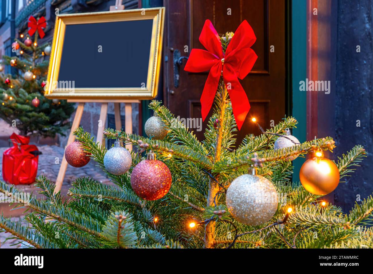 Dekorierter Weihnachtsbaum mit Bilderrahmen zur Beschriftung im Hintergrund Stockfoto