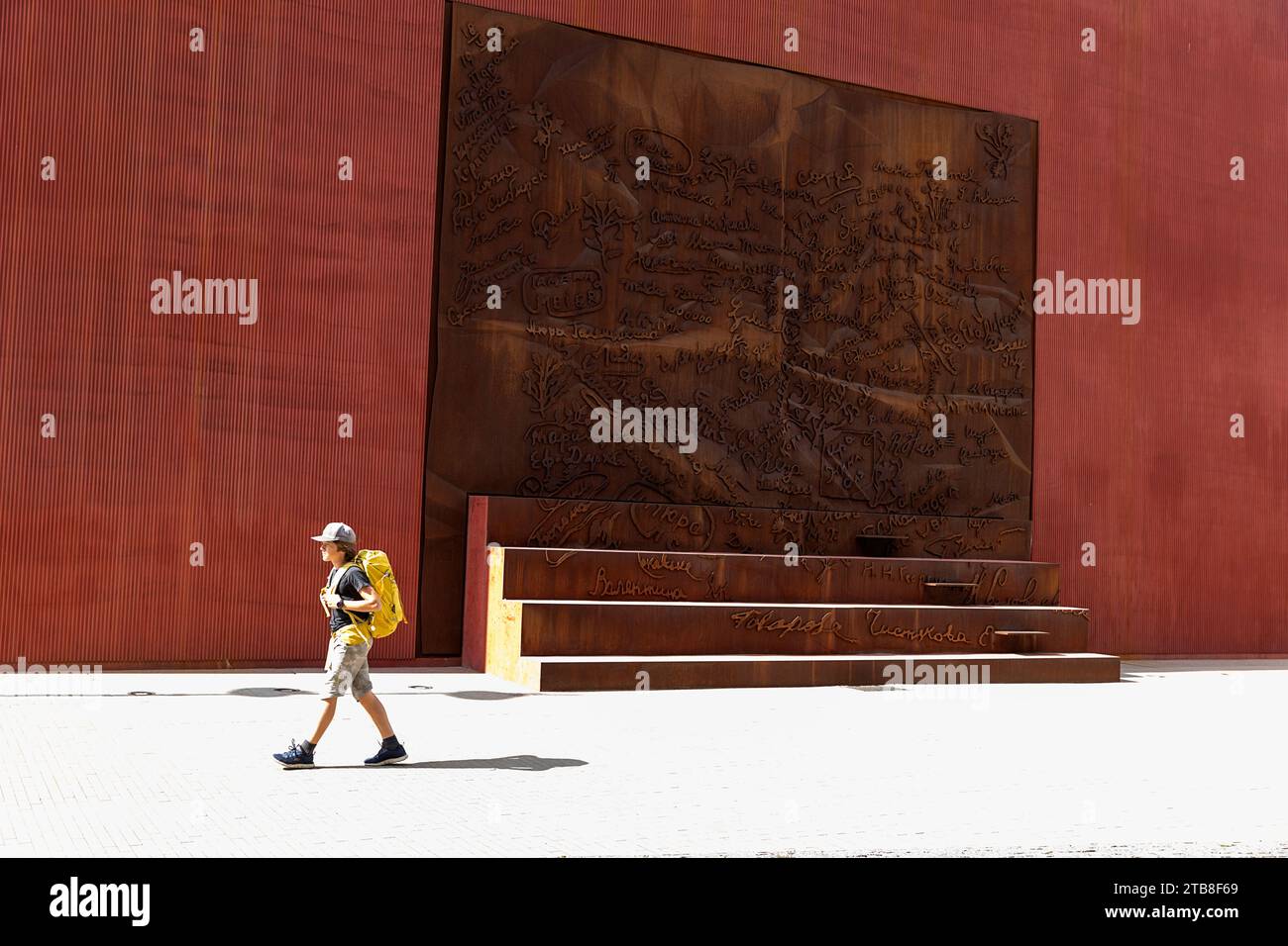 Touristen-Rucksacktouristen spazieren am Denkmal für die Opfer der sowjetischen Besatzung „Geschichtstaktil“ in Riga, Lettland Stockfoto