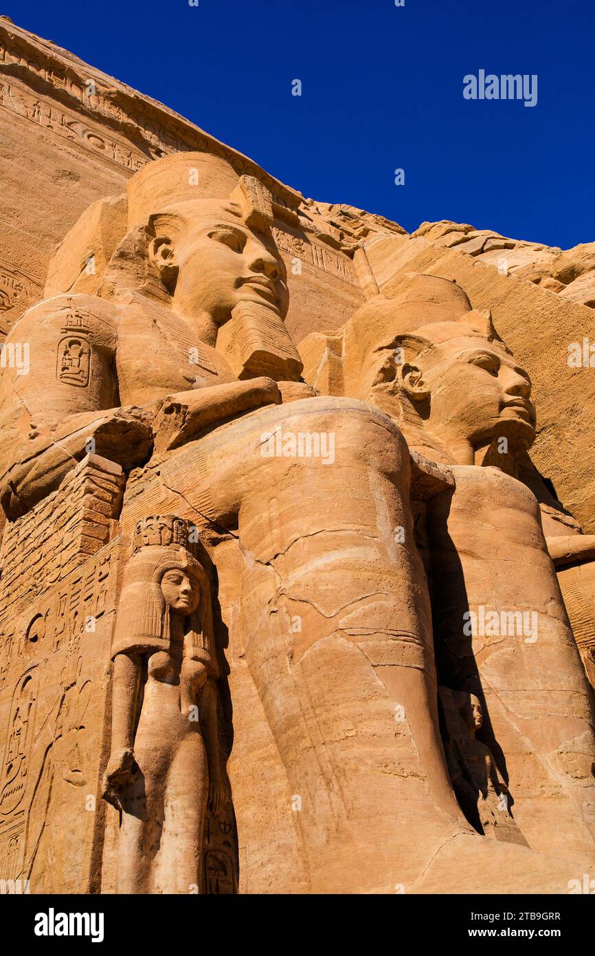 Nahaufnahme von zwei der Ramses II-Statuen, die aus dem Berghang vor dem Großen Sonnentempel von Abu Simbel gemeißelt wurden; Abu Simbel, Nubien, Ägypten Stockfoto