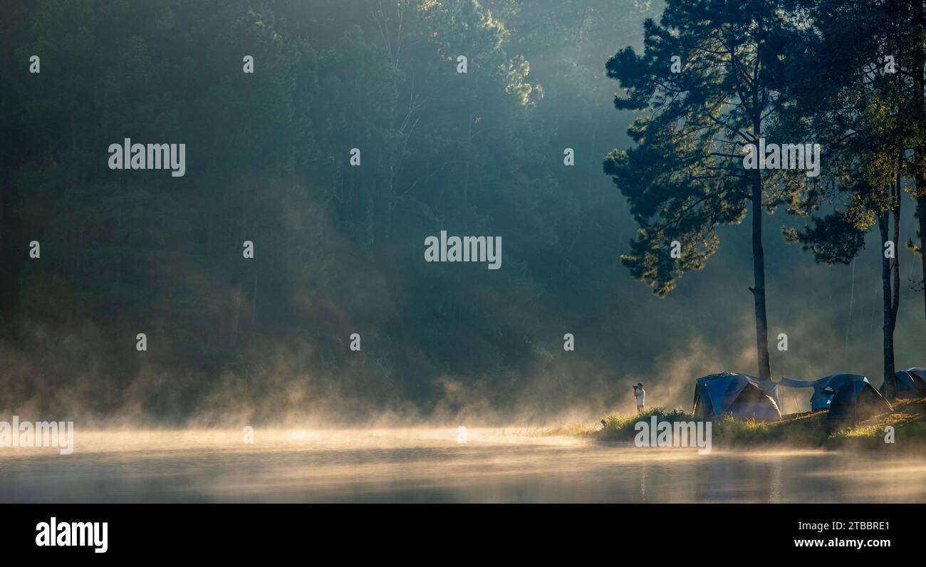 Fotografen reisen und campen allein im Naturpark in Thailand. Der Fotograf fotografiert Morgennebel Stockfoto