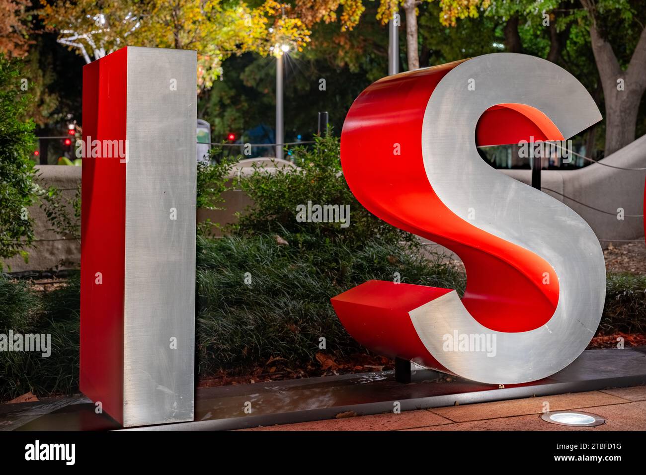 Rote und graue dreidimensionale 3D-Buchstaben, die das Wort bilden, haben einen abendlichen Hintergrund im Freien. Stockfoto
