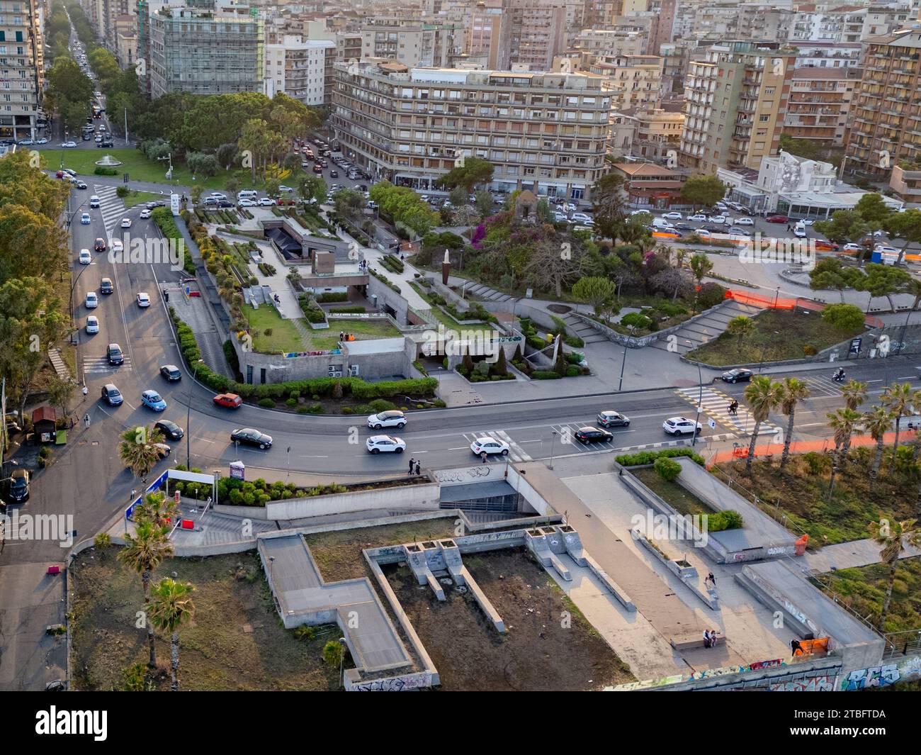 Eine Luftperspektive fängt den dynamischen Verkehr und die Stadtgestaltung von Catania am Ende des Tages ein. Zeigt die Mischung aus Fahrzeugbewegung und e Stockfoto