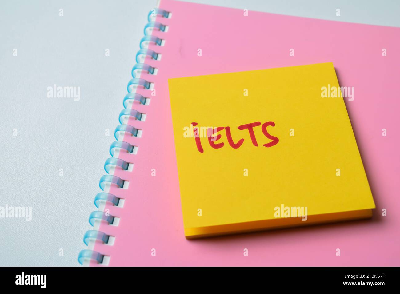 Konzept von IELTS - International English Language Testing System Schreiben Sie auf Haftnotizen isoliert auf weißem Hintergrund. Stockfoto