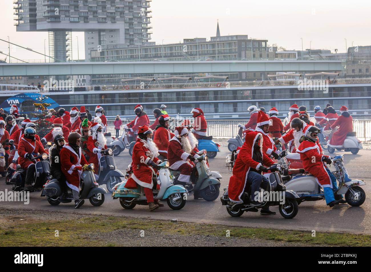 Mitglieder des Vespa-Rollervereins RheinSchalter Köln, als Santas gekleidet, treffen sich auf der Deutzer Werft vor einer Fahrt durch die Stadt Köln. Die Stockfoto