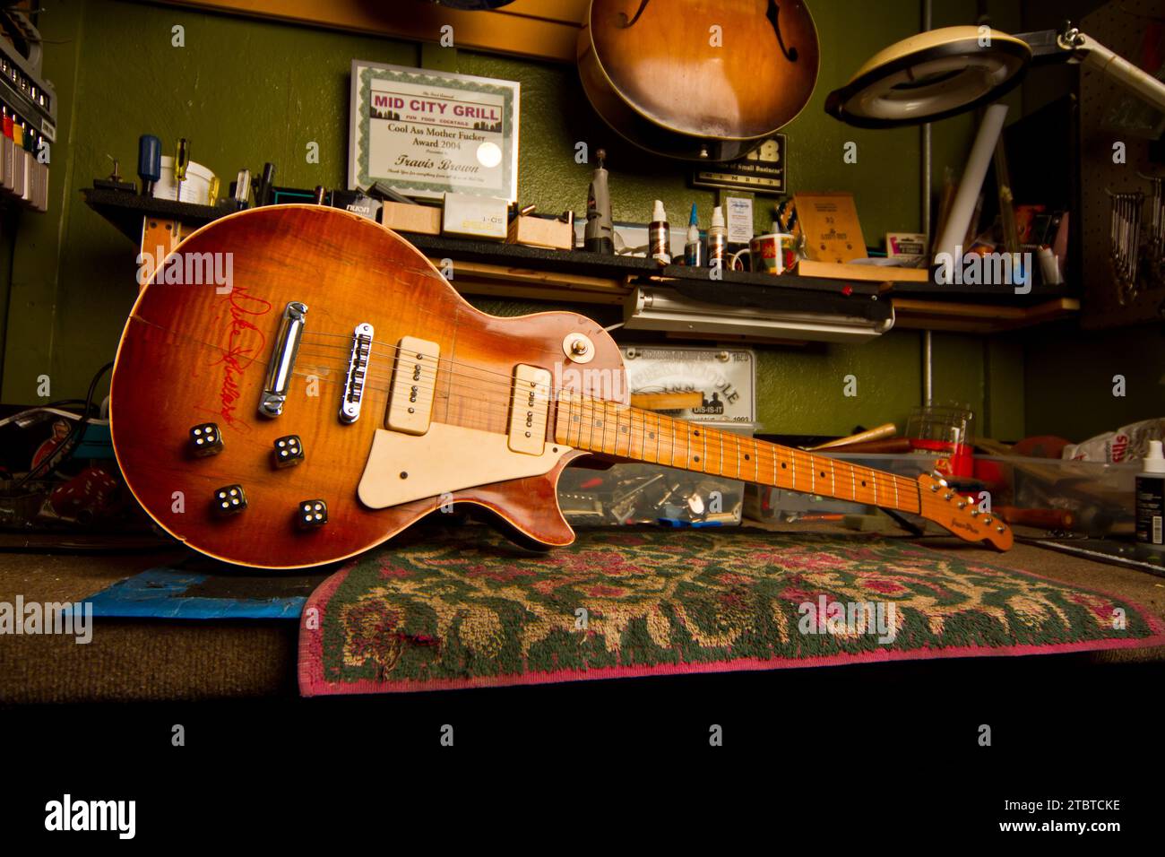 Intimer Einblick in das persönliche Studio eines Musikers mit Vintage-Gitarre und Erinnerungsstücken Stockfoto