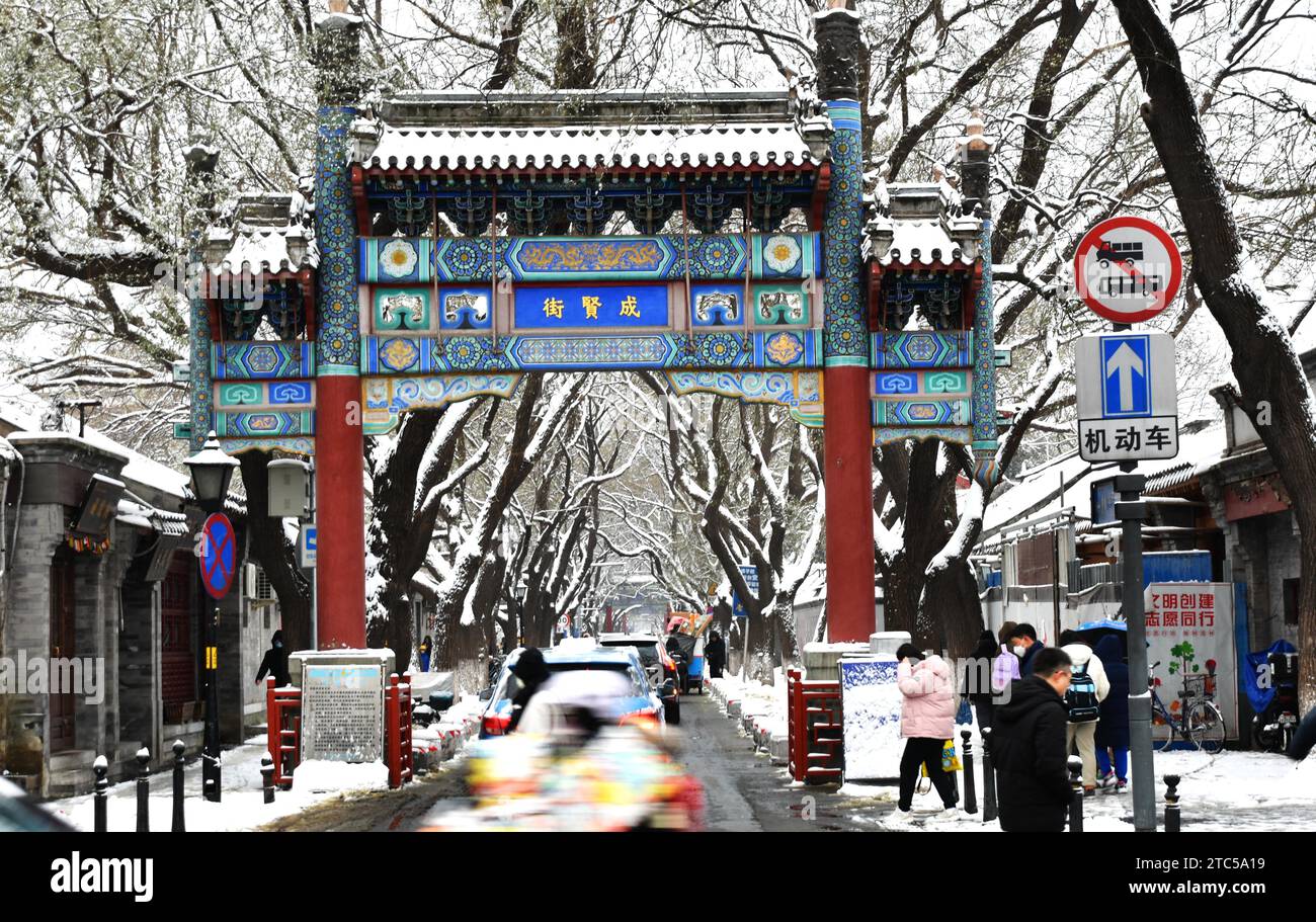 PEKING, CHINA - 11. DEZEMBER 2023 - Menschen mutigen Schnee auf der Guozijian Straße in Peking, China, 11. Dezember 2023. Stockfoto