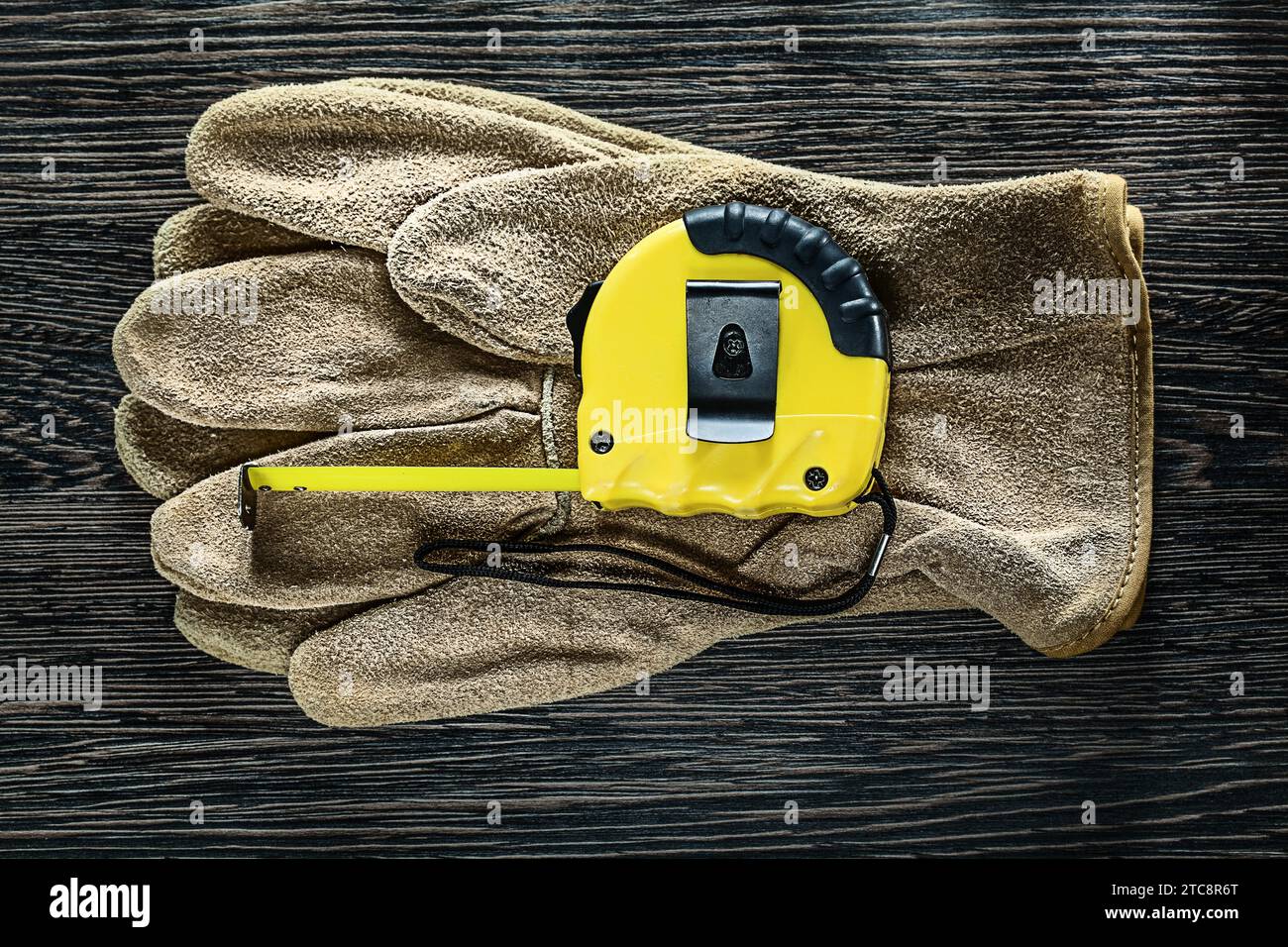 Schutzhandschuhe aus Tapeline-Leder auf Holzbrett Stockfoto