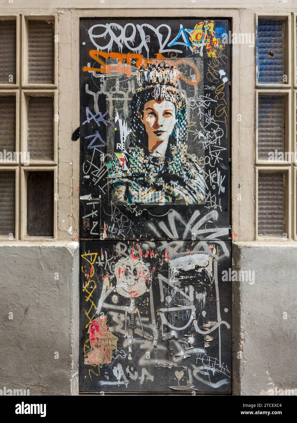 Wandbild, das die Büste einer Frau darstellt, umgeben von Graffiti. Barcelona, Spanien Stockfoto