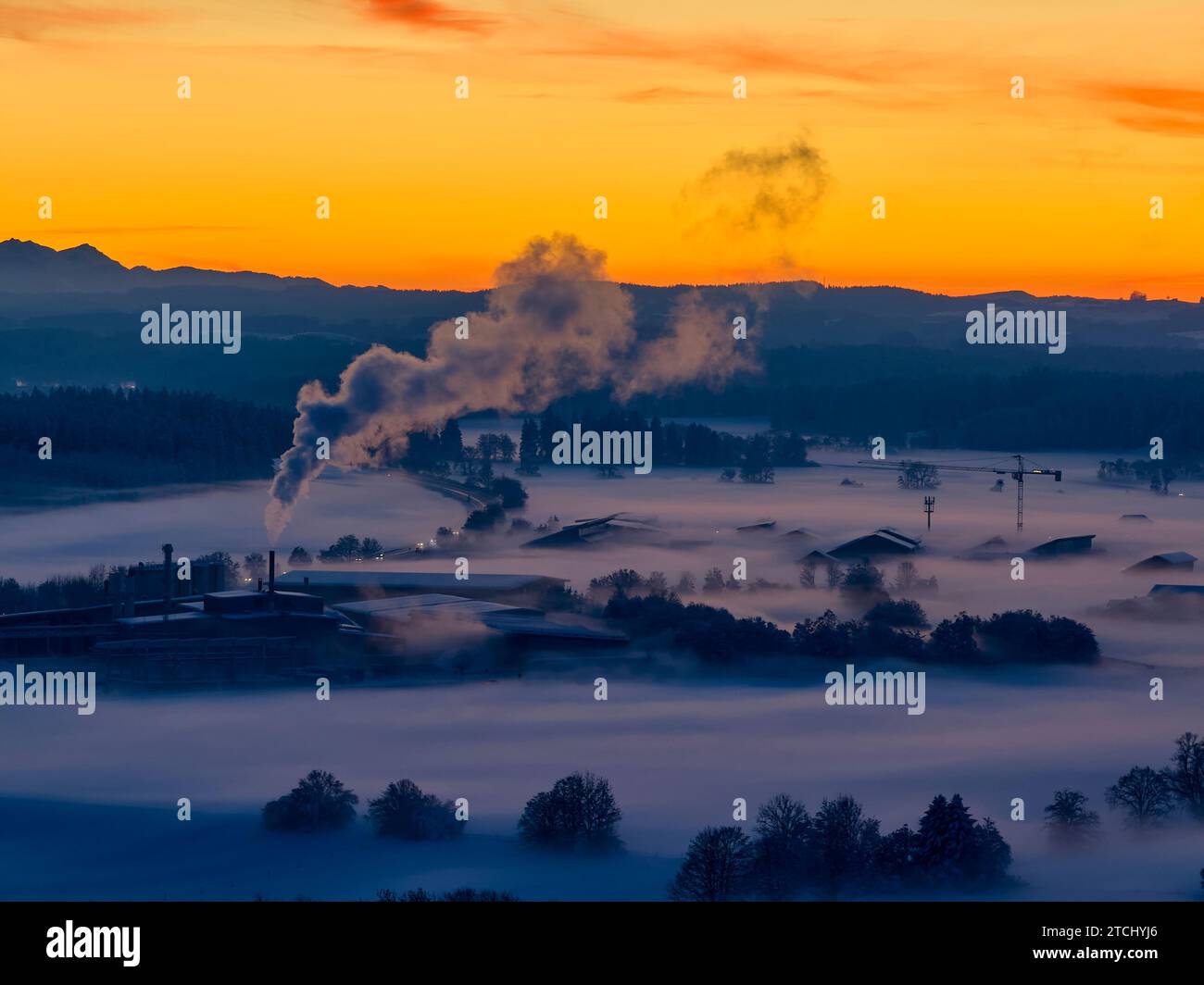 Drohnenfoto der bayerischen Landschaft mit Stadtblick, grüner Energieversorger Brennpunkt Energie GmbH mit Nebel am Abend kurz nach Sonnenuntergang in Marktoberdorf, Deutschland, 3. Dezember 2023. © Peter Schatz / Alamy Stock Photos Stockfoto