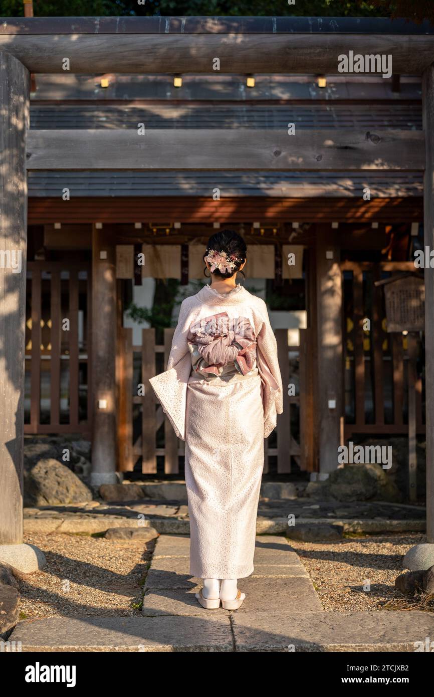 Japanischer Kimono Porträt Rückansicht. Kyoto, Japan. Traditioneller japanischer Schrein Torii. Stockfoto