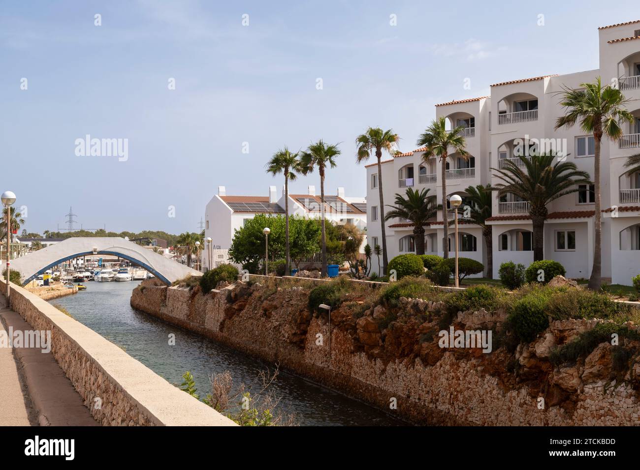 Kanal und Brücke am Hafen in der Küstenstadt Cala en Bosc auf der spanischen Insel Menorca. Stockfoto
