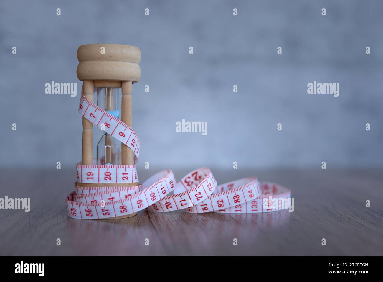 Nahaufnahme von Sanduhr und Maßband. Kopierbereich für Text. Diät- und Gewichtsreduktion-Konzept. Stockfoto