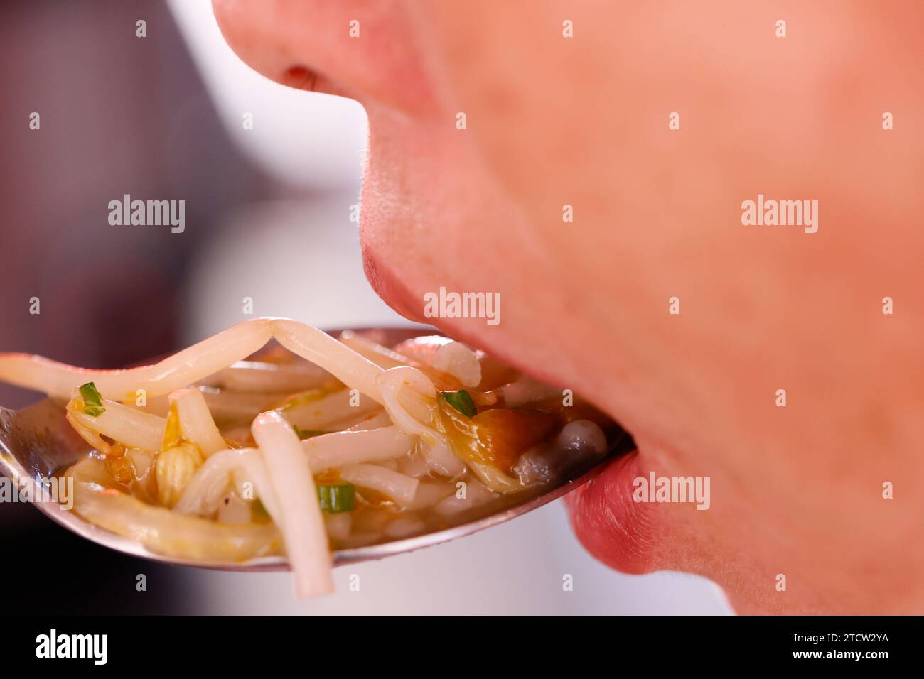 Frau isst chinesische Suppe. Nahaufnahme auf Löffel. Stockfoto