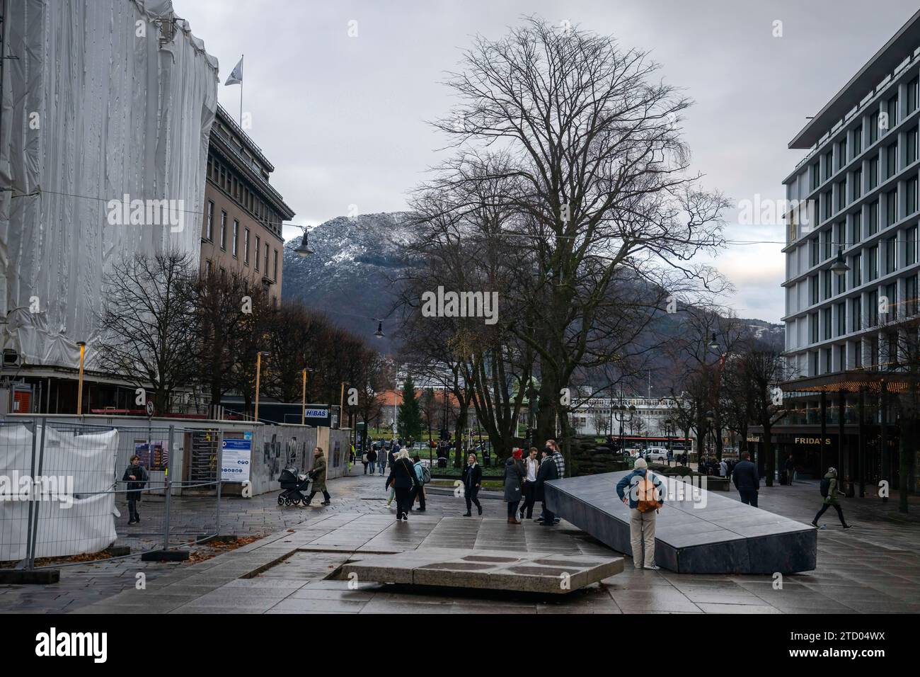 Man sieht Menschen, die auf dem Kong Olav Square in der Innenstadt von Bergen herumlaufen. Bergen, Norwegens zweitgrößte Stadt, liegt an der Südwestküste und ist bekannt als Tor zu den berühmten Fjorden, was sie zu einem der größten touristischen Kreuzfahrthäfen Europas macht. Stockfoto