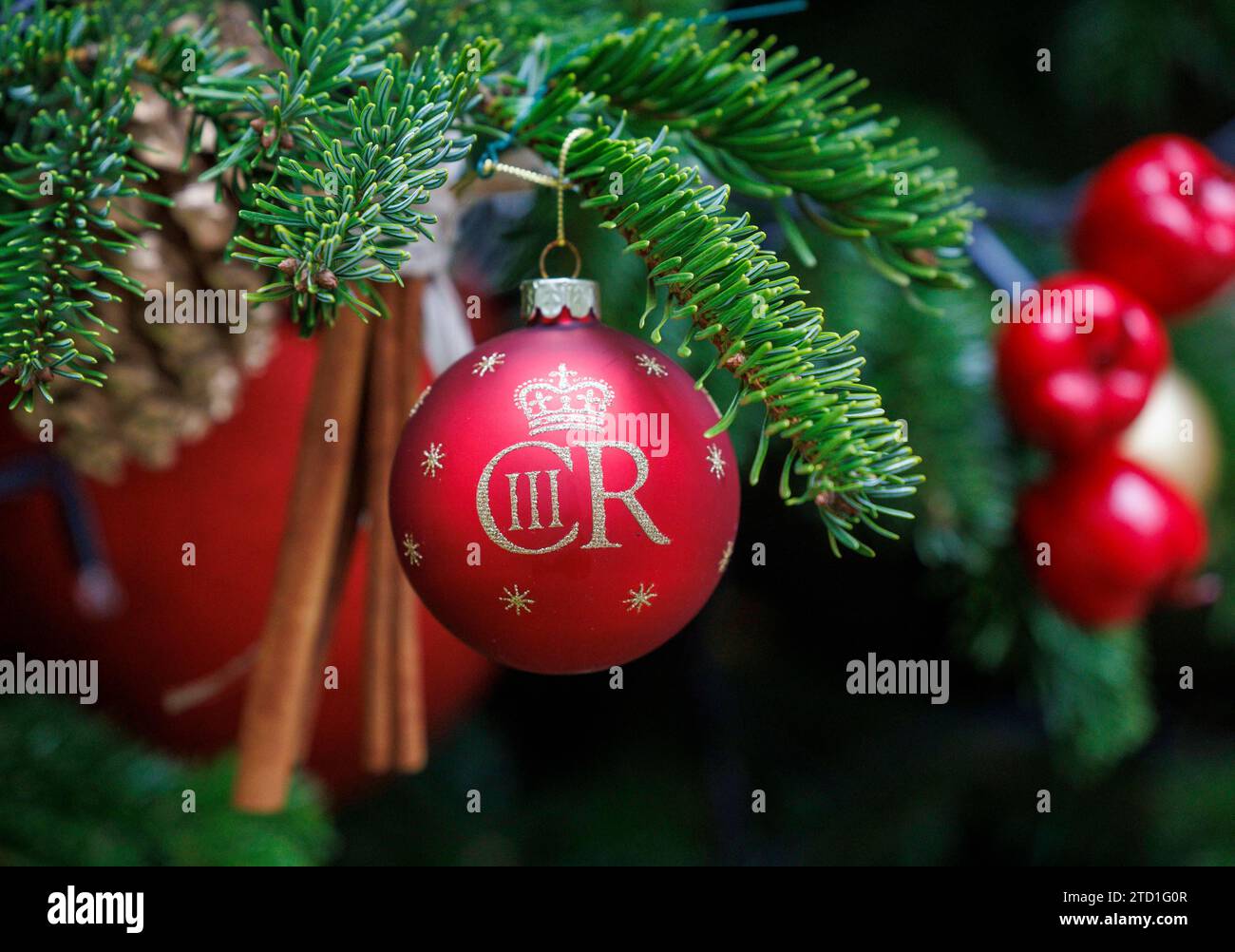 London, Großbritannien 15 Dez 2023 Ein Baubel mit einem König Charles dem dritten Zeichen, Tribut an den neuen König. Der Weihnachtsbaum in der Downing Street vor der Tür von Nummer 10, dem Haus des britischen Premierministers. Stockfoto