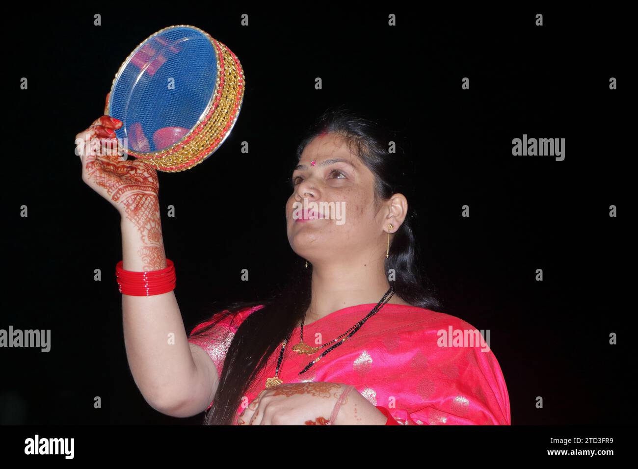 Eine Frau schaut durch das Sieb auf den Mond. Dehradun. Uttarakhand. Indien. Asien. Stockfoto