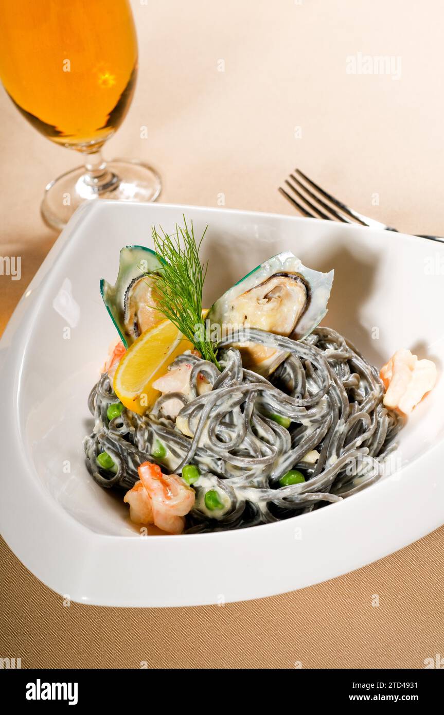 Frische Meeresfrüchte, schwarze Tintenfisch-Tinte, Spaghetti, Pasta, italienische Gerichte, Lebensmittelfotografie Stockfoto