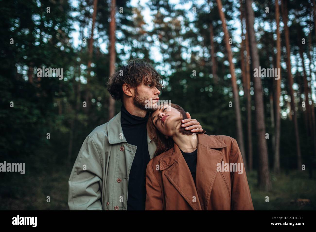 Romantische Liebespaare bei einem Date im Park bei kaltem Wetter. Modisches Paar im Mantel Stockfoto