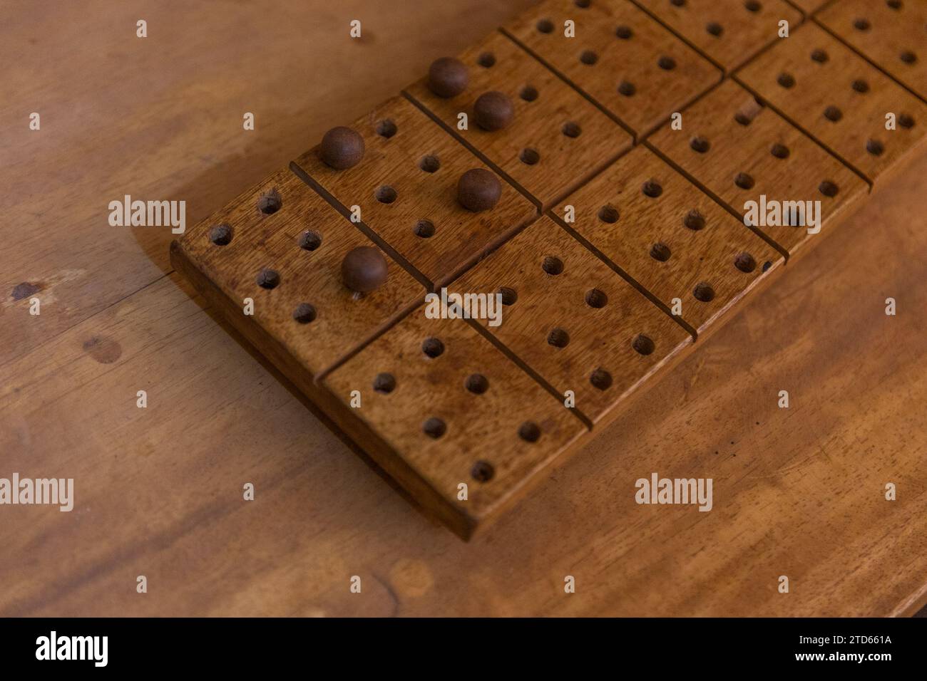 brailleschrift aus Holz mit Marmor auf einer Holzoberfläche. BRAILLE-SCHRIFT-Konzept. Stockfoto