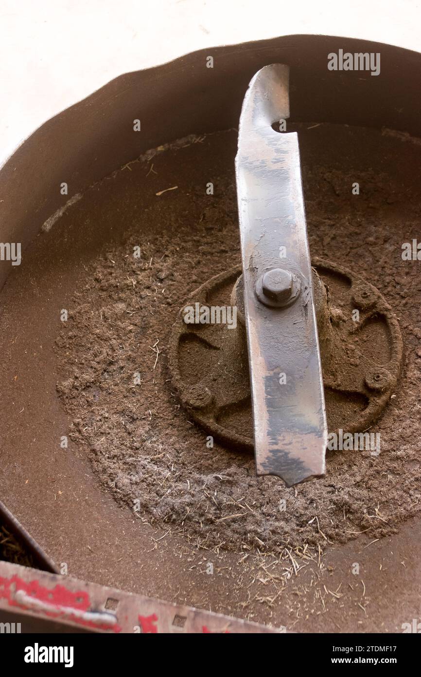 Gerissene, gebrochene Klinge des Aufsitzrasenmähers, die noch an der Unterseite des Daches des Toro 60-Zoll-Aufsitzmähers befestigt ist. Zum Ausbau und Austausch Stockfoto
