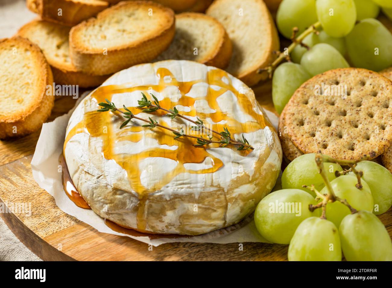 Hausgemachte, gebackene Brie-Vorspeise mit Trauben und Crackern Stockfoto