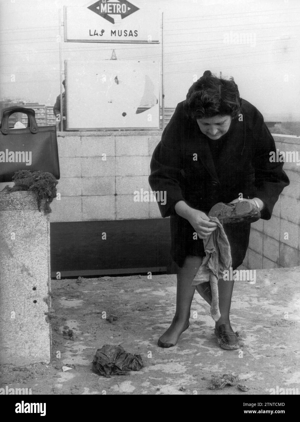 Madrid, 10.03.1975. Abfahrt von der U-Bahn „Las Musas“. Szenen wie diese wurden oft wiederholt. Die Schuhe waren mit einer dicken Schlammschicht bedeckt. Einige bedeckten sie mit Plastiktüten, um den Weg von ihren Häusern zu beschreiten. Quelle: Album / Archivo ABC / Luis Ramírez Stockfoto