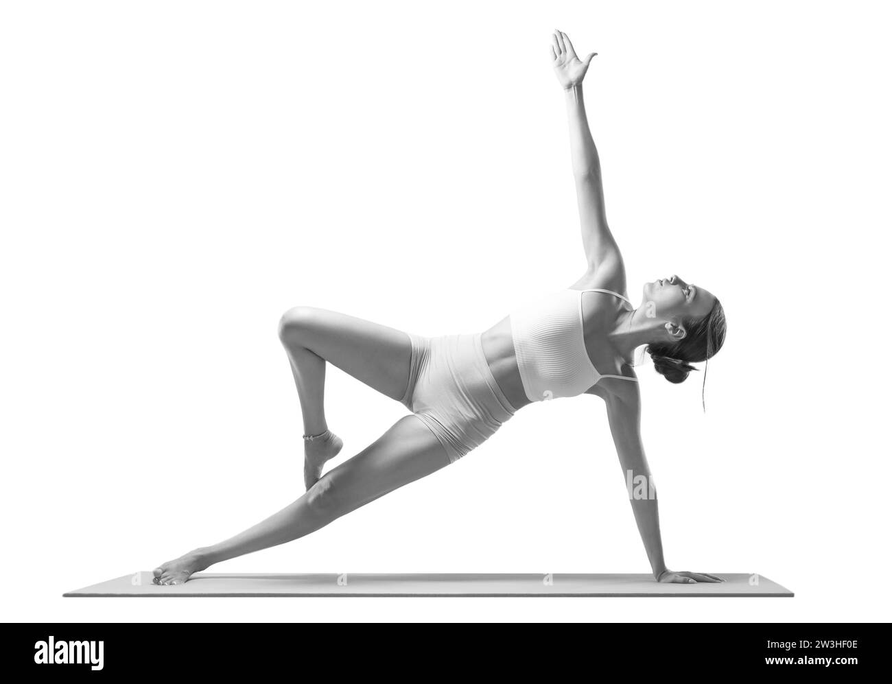 Sportliche junge Frau, die Yoga übt. Isoliert auf weißem Hintergrund. Das Konzept eines gesunden Lebensstils und des natürlichen Gleichgewichts zwischen Körper und Stockfoto