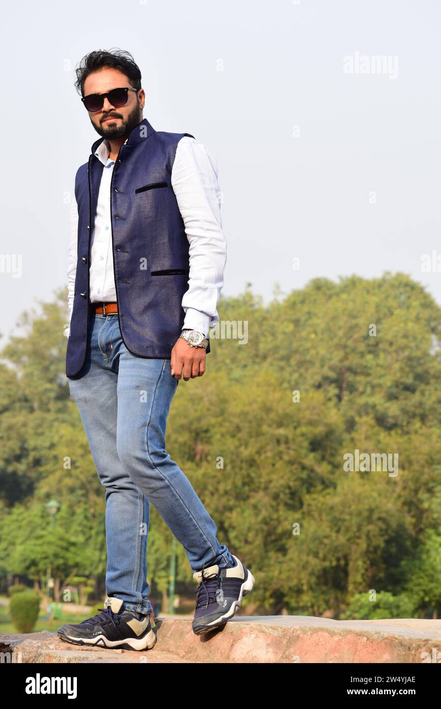 Stilvolles indisches Modell Mann in Freizeitkleidung schwarz weißes Hemd mit blauer Jacke und Sonnenbrille perfektes Foto für den kommerziellen Gebrauch. Stockfoto