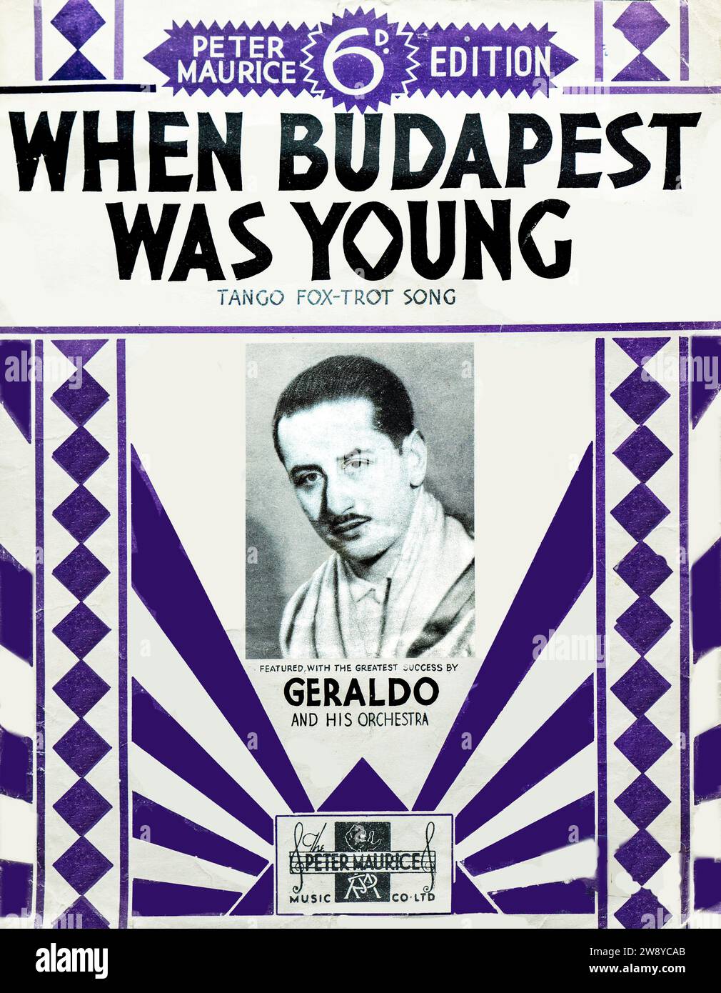 Vintage Notencover When Budapest Was Young, ein Tangofox-Trab-Song von Peter Maurice Music Co. Ltd., London, ca. 1930s. Diese Ausgabe zeigt den britischen Tanzkapellmeister Geraldo und sein Orchester, das für ihren großen Erfolg in der Zwischenkriegszeit bekannt ist. Das auffällige geometrische Art déco-Design mit violetten Akzenten spiegelt den visuellen Stil des Musikverlags der 1930er Jahre wider. Das Stück hebt sowohl den kontinentalen musikalischen Einfluss als auch die Prominenz der Londoner Tanzbandkultur hervor. Stockfoto