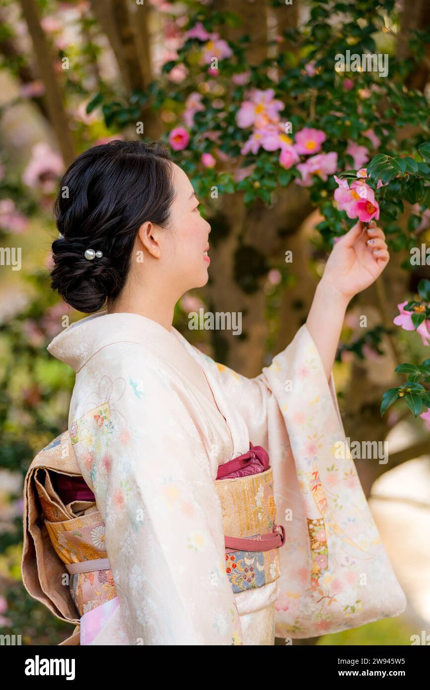 Japanische Kimono-Porträtfotografie mit Blumen in voller Blüte. Stockfoto