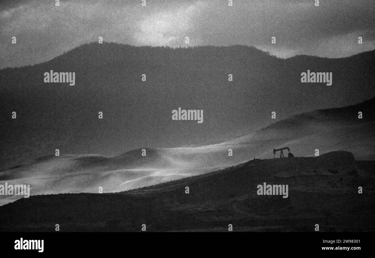 Eine einsame Ölpumpe auf einem Hügel in CA. (Körnig) Stockfoto