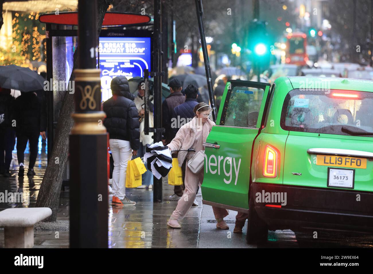 London, Großbritannien, 27. Dezember 2023. Die Käufer trotzten den böigen Winden und starken Regenschauern von Storm Gerrit auf der Oxford Street, als die Verkaufszahlen am Boxing Day weitergingen. Trotz des Sturms bleiben die Temperaturen ungewöhnlich mild. Kredit : Monica Wells/Alamy Live News Stockfoto