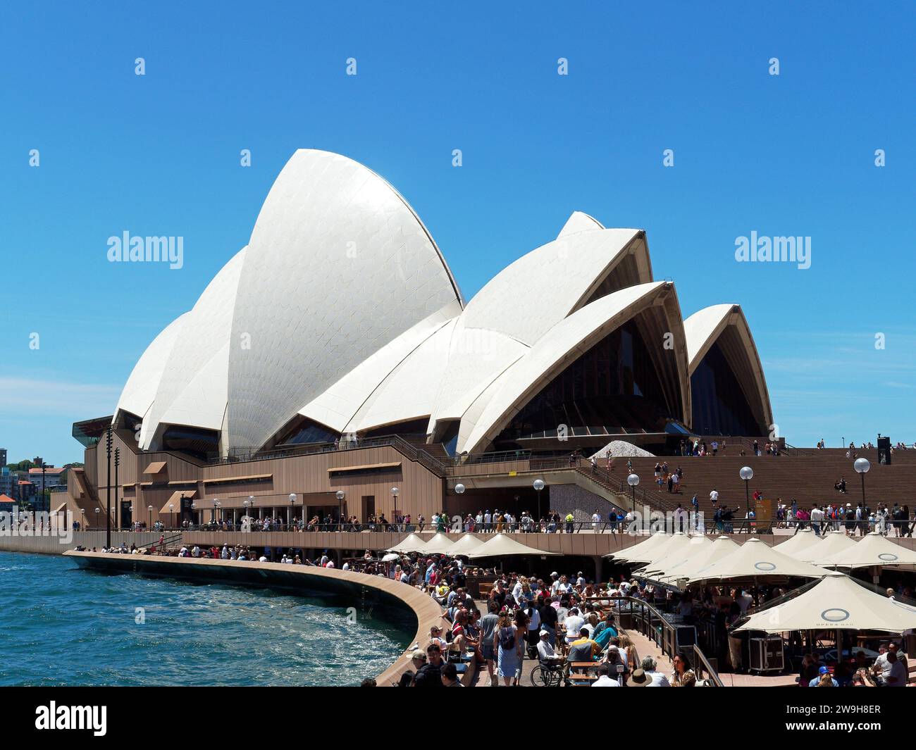 Blick auf das berühmte Opernhaus von Sydney im Hafen von Sydney die mit Touristen und Besuchern überfüllten Hallen an einem sonnigen Frühlingstag im November Stockfoto