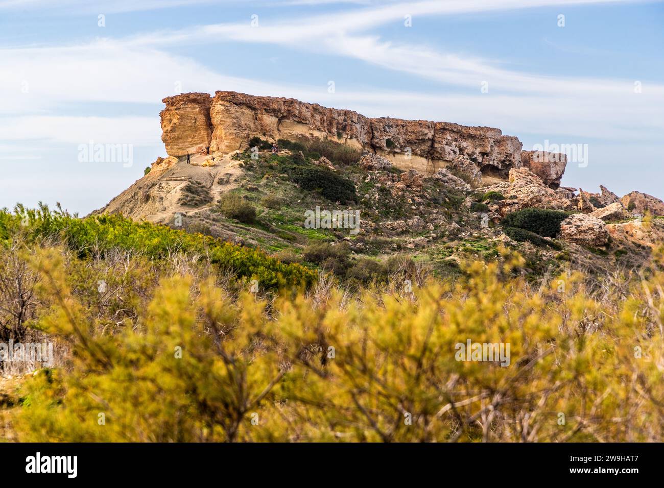 Għajn Tuffieħa-Bucht mit Il-Qarraba-Felsen. Strand mit dunklem Sand, beliebt zum Surfen und in einer Bucht, die von Hügeln umgeben ist, mit einem Küstenpfad in der Nähe von L-Imġarr, Malta Stockfoto