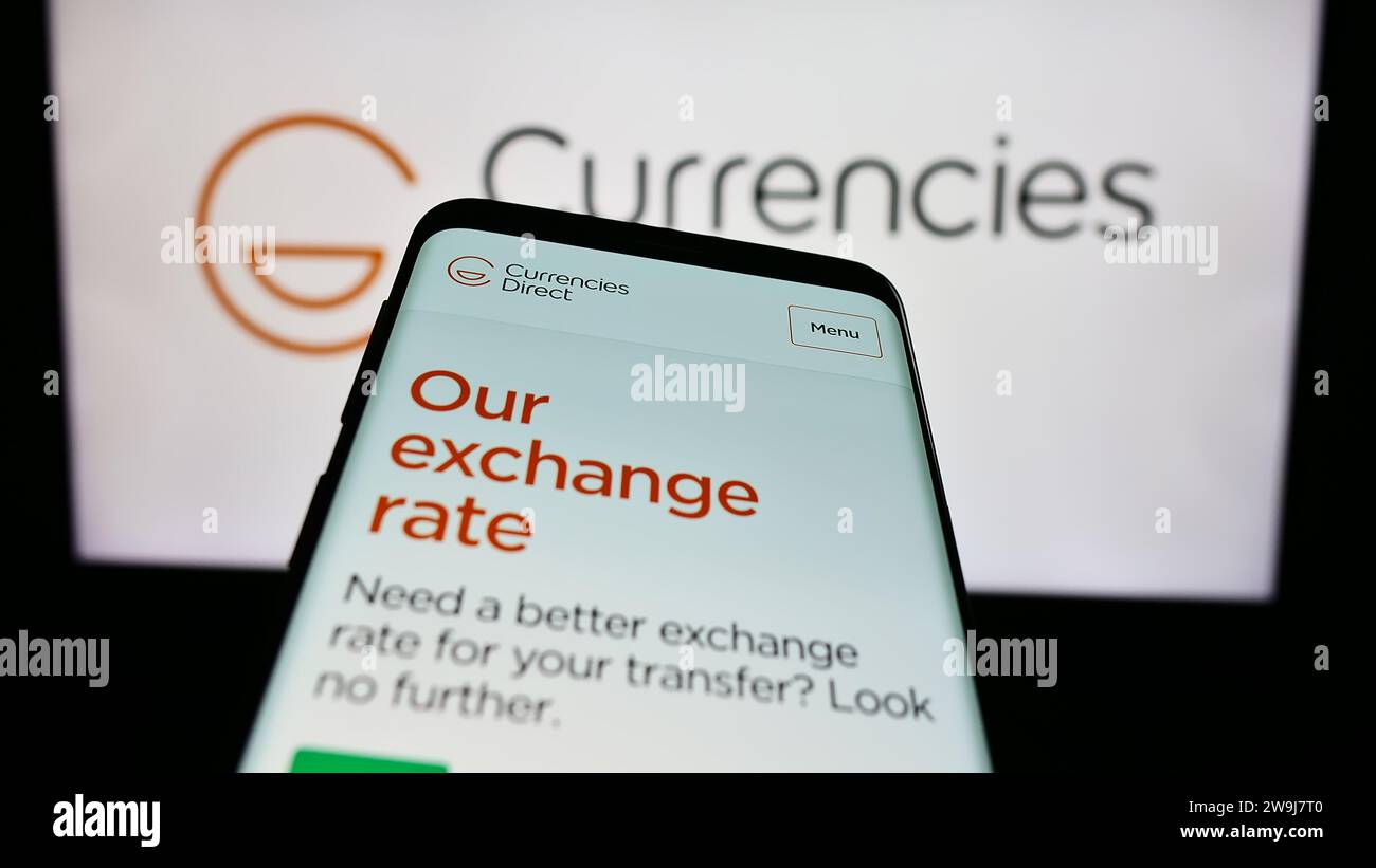 Smartphone mit Website des britischen Geldtransferunternehmens Currency Direct Ltd. Vor dem Firmenlogo. Fokussieren Sie sich oben links auf der Telefonanzeige. Stockfoto