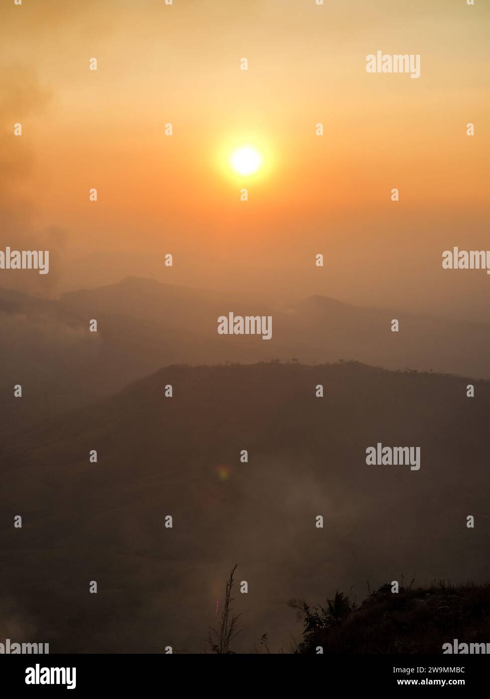 Waldfeuer und weißer Rauch oder Waldfeuer vom Feuer auf dem Berghügel der Dorffarm oder Plantage in der Nähe des Waldes in Thailand, Asien. Ungesunde Luft Stockfoto