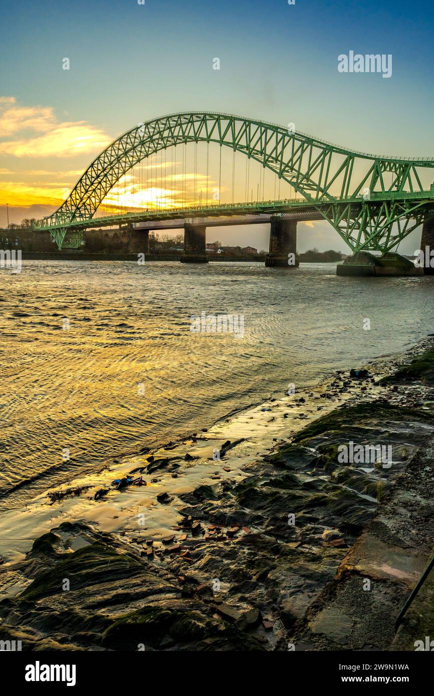 Sonnenuntergang über der Queensway Jubilee Bridge über den Fluss Mersey zwischen Widnes und Runcorn in Halton. Stockfoto