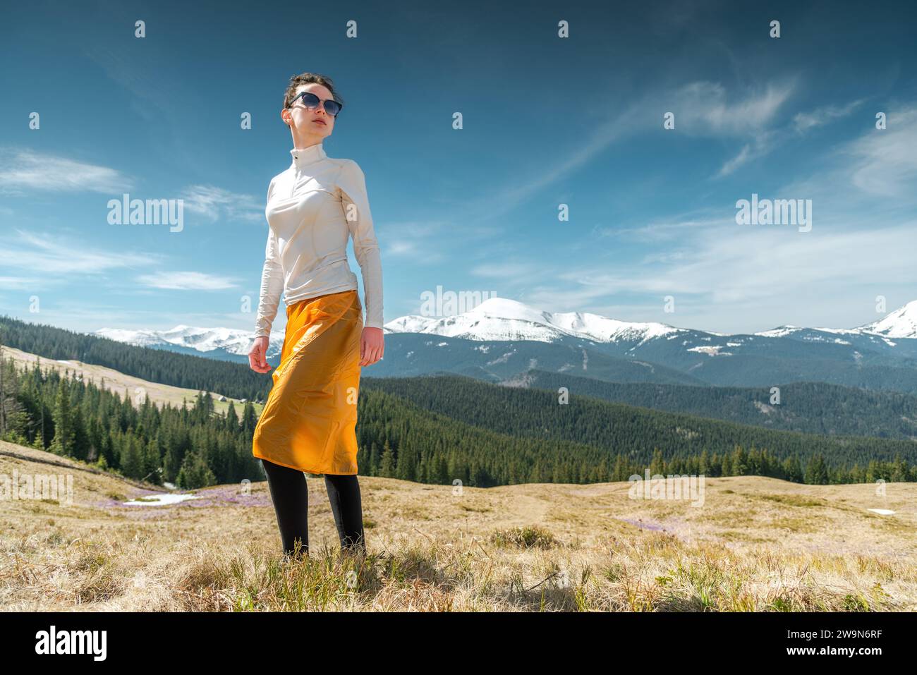 Junge Frau auf einem Wanderausflug in die Berge, die die Aussicht genießen Stockfoto