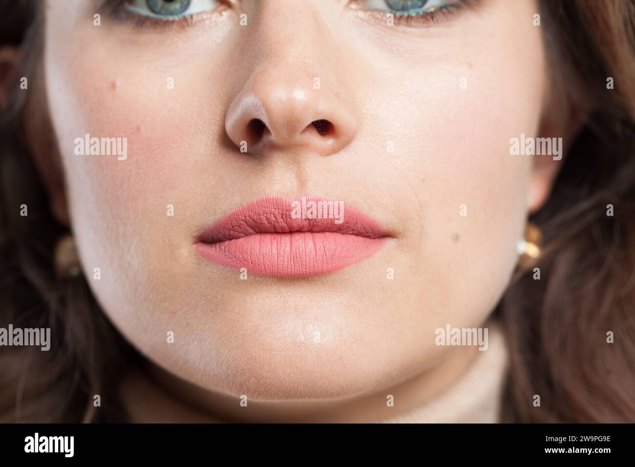 Lippen mit rosafarbenem mattem Lippenstift-Nahaufnahmebild Stockfoto