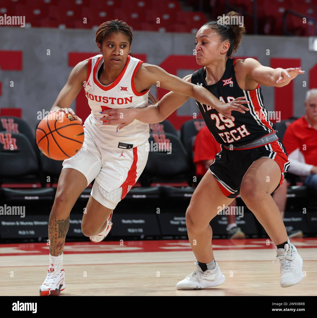 30. Dezember 2023: Houston Guard N’Yah Boyd (5) schiebt den Ball gegen den Texas Tech Guards Ashley Chevalier (25) während eines NCAA-Basketballspiels zwischen den Houston Cougars und den Texas Tech Red Raiders am 30. Dezember 2023 in Houston. (Kreditbild: © Scott Coleman/ZUMA Press Wire) NUR REDAKTIONELLE VERWENDUNG! Nicht für kommerzielle ZWECKE! Stockfoto