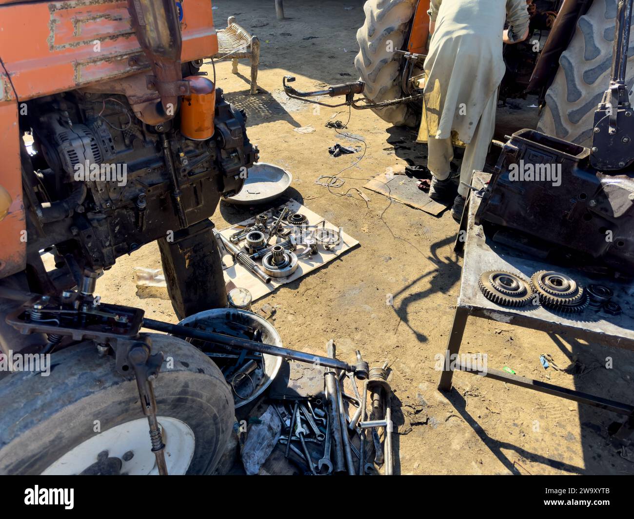 Traktormechaniker überholen den Traktormotor in der Werkstatt: 04. Dezember 2023 - SWAT, Pakistan. Stockfoto