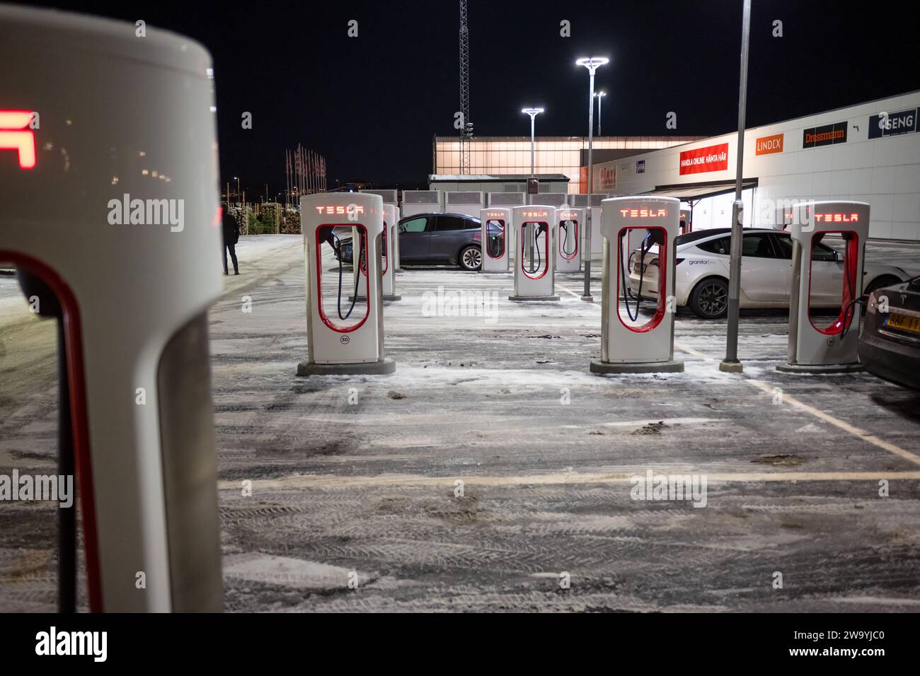 Göteborg, Schweden - dezember 09 2022: Autos laden nachts an Tesla Supercharger auf Stockfoto