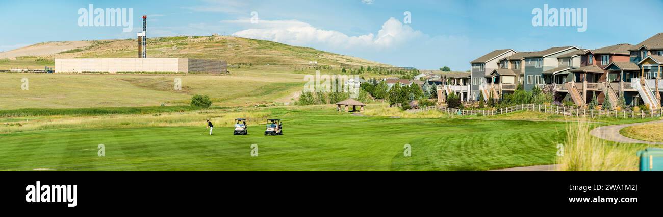 Panorama eines Mannes, der Golf spielt, während Öl- und Gasbohrungen im Hintergrund stattfinden, Erie, Colorado, USA Stockfoto