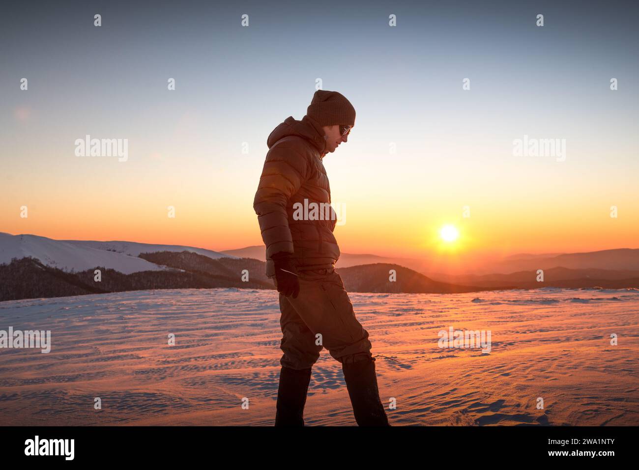 Young Man Trail Wandern In Den Winter Mountains Bei Sonnenuntergang Stockfoto