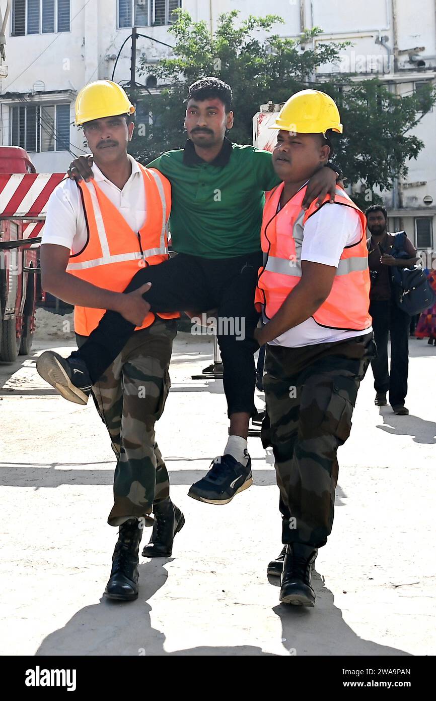 Feuerwehrleute versuchen, ein Feuer auf dem Dach des Gebäudes der Zahnarztschule während einer landesweiten Scheinübung am Erdbebentag in Agartala zu kontrollieren. Tripura, Indien. Stockfoto