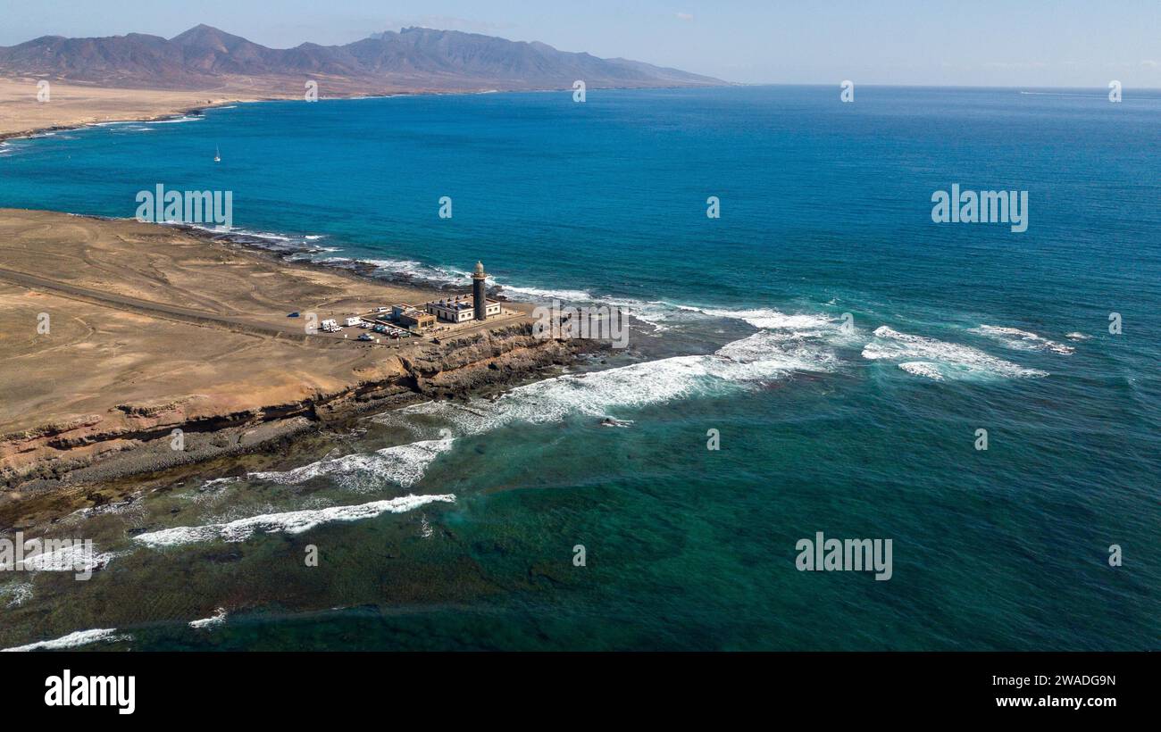 Luftaufnahme des Leuchtturms Faro Punta de Jandia an der südlichen Spitze der Halbinsel Jandia, im Vordergrund weiße weiße Whitecaps auf bewegtem Meer schwellen am Riff Stockfoto