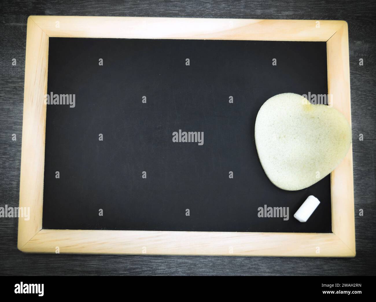 Schwarze Tafel mit Schwamm und Kreide Stockfoto