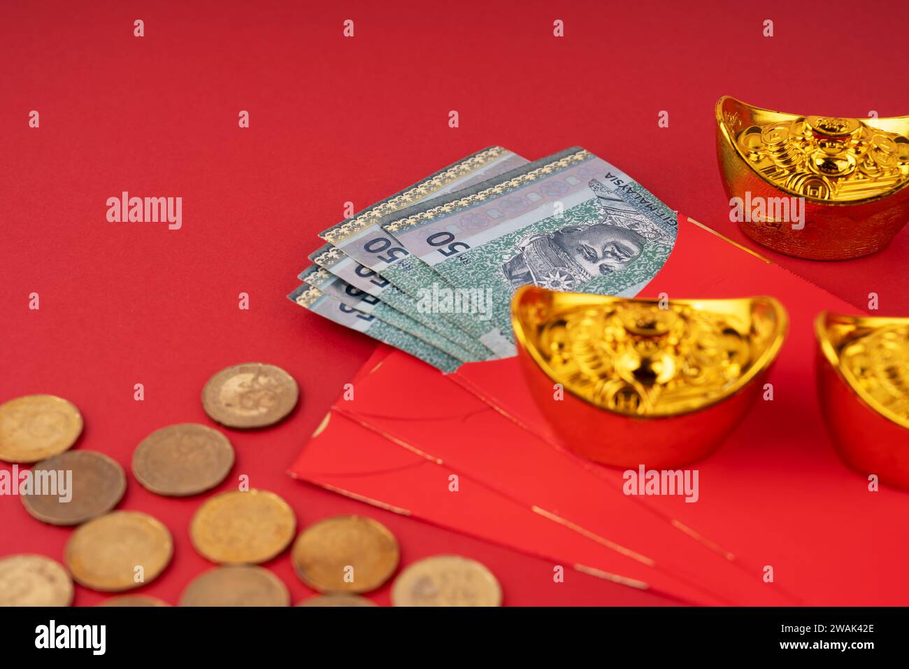 Roter Umschlag angpow mit 50 Ringgit Malaysia, Goldmünzen und Barren Stockfoto